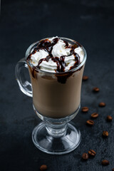 Coffee with cream and chocolate syrup in a mug.