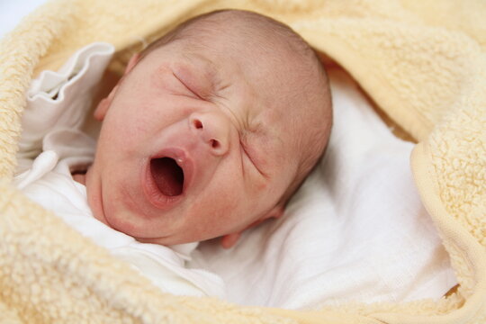 baby waking up after a good night sleep with people stock photo