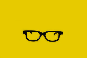Glasses on a bright yellow background