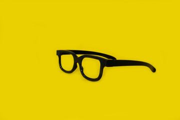 Glasses on a bright yellow background