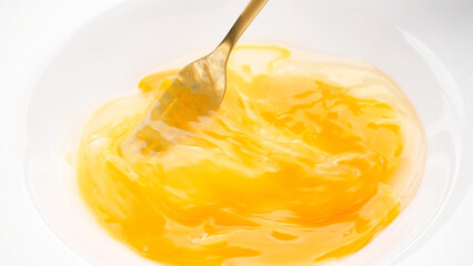 Stirring eggs with fork in white plate, close up. Cooking French omelette