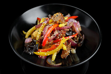 Veal with vegetables and spices, on a dark background