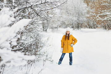 A girl walks in a winter park