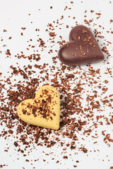 Top view of two chocolate hearts on a white background, flat lay, close-up. Valentine's Day concept