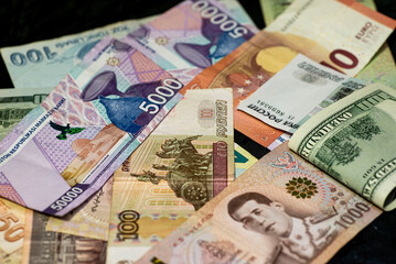Fototapeta na wymiar money from different countries in one pile close-up