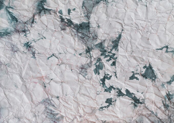 Crumpled paper with paint stains. The texture of crumpled paper.