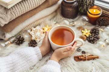 Fototapeta na wymiar Cup of tea in hands, aesthetic winter photo
