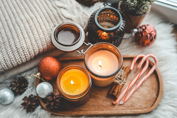 Fototapeta na wymiar Burning candles in Christmas home interior, atmospheric cozy photo
