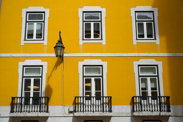 Set of classical European windows againts a bright yellow painted wall, classical European...