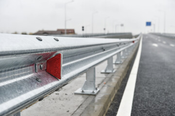 Brand new metallic road barrier for traffic safety on a new constructed road - 547779877