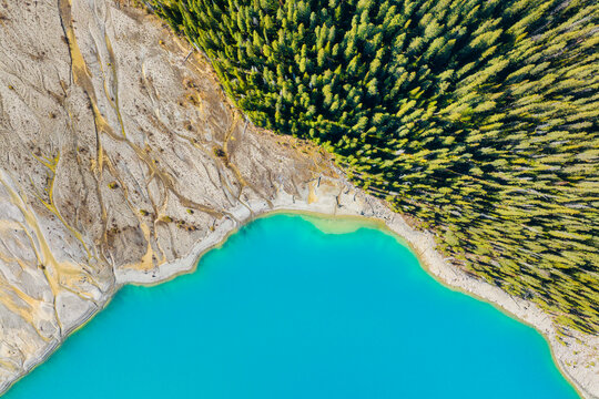 Drone view of the lake and forest in the glacier valley. View of the moraines. Landscape from the air.  River on a moraine. Landscape from drone. Abstract view for wallpaper. Alberta, Canada.