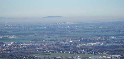 View to vienna airport in the distance with a starting airplane