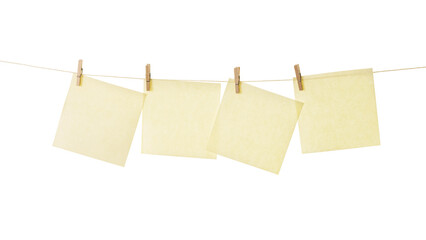 Four square notes papers hanging from miniature clothespins isolated with clipping path