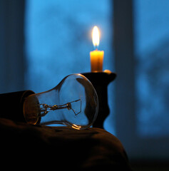 In the absence of electricity supply, a candle is lit