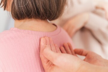 Close-up shot of female hands giving shoulder massage to a pregnant woman - Hypnobirthing concept