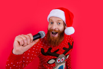 christmas music party. happy man at christmas music party with microphone. christmas santa man