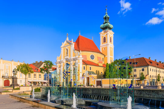 Gyor, Hungary. Carmelite Church and water fountain.