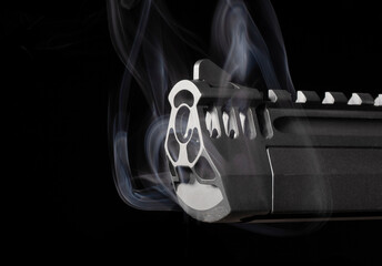 Smoking semi-automatic pistol on black
