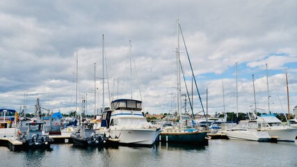 Fototapeta na wymiar Boats Anchored At Harbor Under Clear, Blue Sky