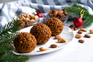 Christmas nut balls cookie on white plate with almond and cashew. Simple homemade cookie with nuts. Recipe of Christmas treats, crispy dessert.