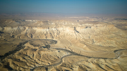 Gorgeous aerial drone top bird's eye view of incredible golden  desert mountains of tzin river. desert in Israel