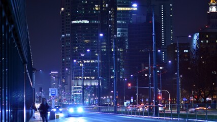 Fototapeta na wymiar Evening city life in the centre. Cars on street. City street lights at night.