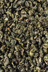 Dry green tea leaves.