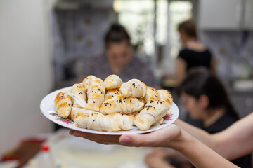 The process of making homemade croissants and other pastries at home. The family is cooking dessert together in the kitchen.