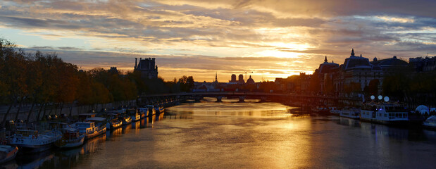 Seine river and Old Town of Paris , France in the beautiful sunrise. A nice skyline of famous touristic destination with Notre Dame de Paris.