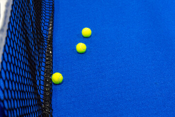 Yellow tennis balls in court on blue turf.  Horizontal sport poster, greeting cards, headers, website