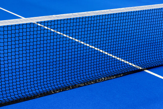 Paddle tennis and tennis net on blue court. Tennis competion concept. Horizontal sport poster, greeting cards, headers, website