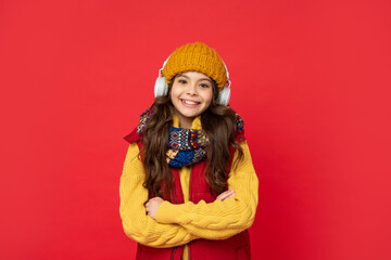 Obraz na płótnie Canvas happy child in hat listening music in headphones, education