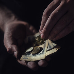 Man hands holding USSR rubles, money on a black background, close-up. Soviet Union cash in the dirty hands of a poor man on a dark background - obrazy, fototapety, plakaty
