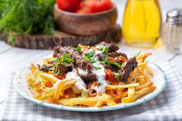 Turkish food; Cokertme Kebab - Beef meat kebab with yoghurt and french fries
