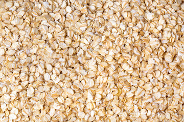 Heap of dry rolled oats isolated