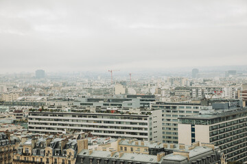 Top view of a European country with lots of green trees and buildings. Image of Paris from above. French state in autumn