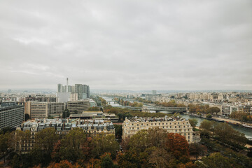Obraz premium Top view of a European country with lots of green trees and buildings. Image of Paris from above. French state in autumn