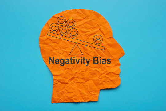 Head from paper and inscription Negativity bias.