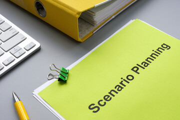 Scenario planning document near a yellow folder.