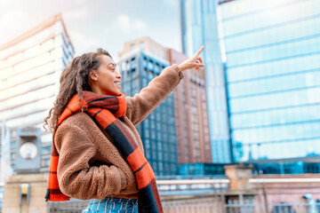 a woman pointing at a modern house. The concept of rent or buying a home or office