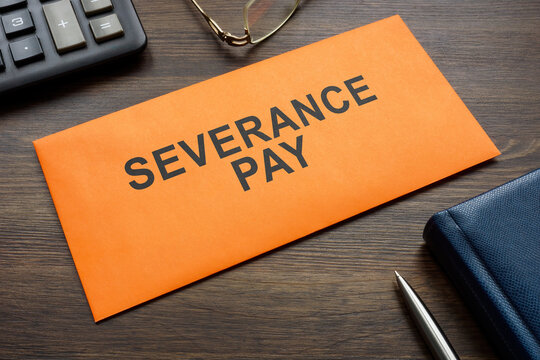 Envelope with sign severance pay on the desk.