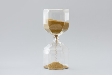 Hourglass on the gray background.