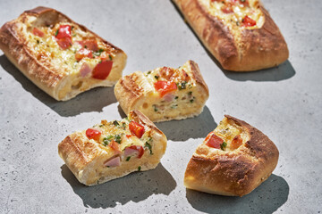 Bread boats stuffed with ham, egg, green onion and cheese for breakfast