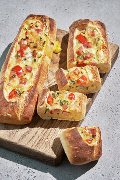 Bread boats stuffed with ham, egg, green onion and cheese for breakfast