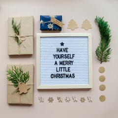 Christmas flatlay letter board spelling Have yourself a merry little Christmas with decorations and wrapped gifts. Holiday card, Christmas greetings concept.