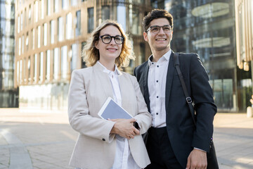 The managers are a man and a woman in business suits. Employees brainstorm people go to the office and work on a new startup and project.