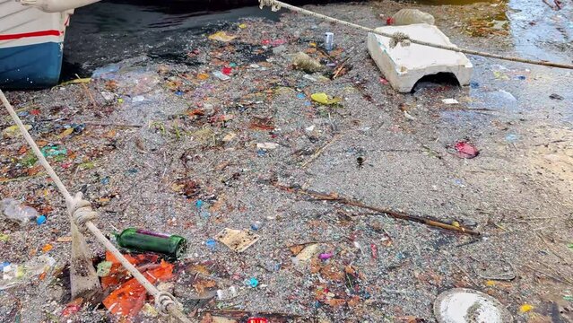 Polluting Garbage on the Sea at the Harbor Beach Footage.