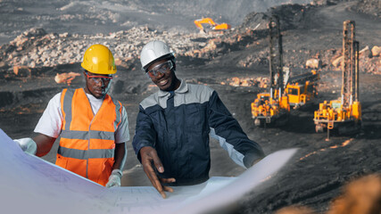 Team african american workers geology with drawing background big drilling yellow mining truck for...