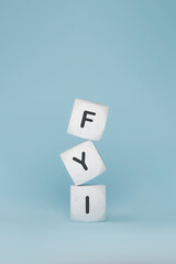 Marble tiles with FYI abbreviation stacked in blue background, 3d rendering. Letter cubes with mock-up with corporate business sign