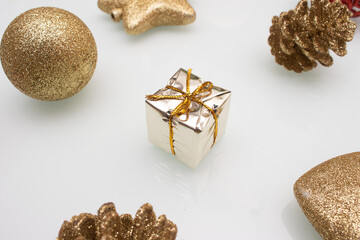 several  golden christmas ornaments on white background